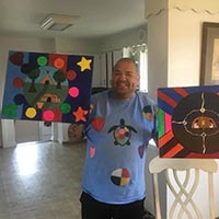 holding up aboriginal artworks