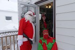 Santa and his elf are happy to visit some friends