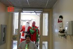 Santa and his elf visiting a building