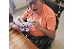 A man holds up his assembled Easter Craft