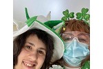 Smiling people wearing fun St. Patty's Day Hats